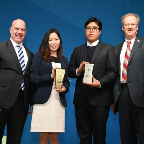 Image of four people holding certificates